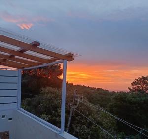 a sunset from the back porch of a house at Scenic View Homestay in Shillong