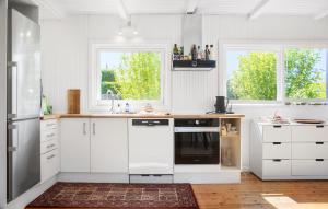 a kitchen with white appliances and two windows at Awesome Home In Ølsted With Wifi in Ølsted