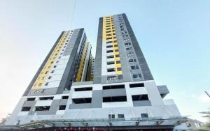 a tall building with two tall buildings at SkyBreeze Sentraland in Medan