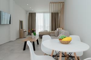 a living room with a white table and chairs at Hotel Apanema in Vivari