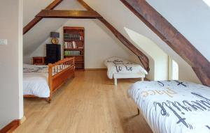 a attic bedroom with two beds and a book shelf at Grande Longère Bretonne in Silfiac +7 photos