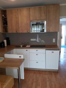 a kitchen with white cabinets and a sink at Koserow, Förster-Schrödter-Str 16 WE 2 in Ostseebad Koserow