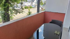 a mirror on a balcony with a view of a street at Anikó Apartman in Siófok
