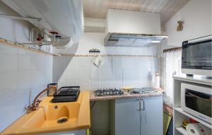a small kitchen with a sink and a stove at 3 Bedroom Stunning Home In Saignon in Saignon