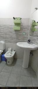 a bathroom with a sink and a toilet at EnjoyCasa Tra Sole Mare e L'Etna in Adrano +13 photos