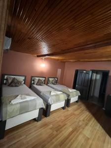 two beds in a room with a wooden ceiling at Langa Esra in Istanbul +68 photos