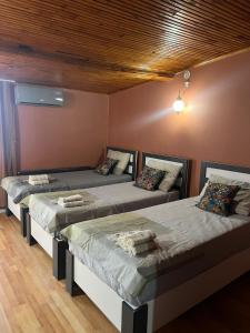 a room with three beds in a room at Langa Esra in Istanbul