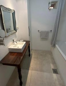 a bathroom with a sink and a mirror at The Konoba in Šibenik +5 photos