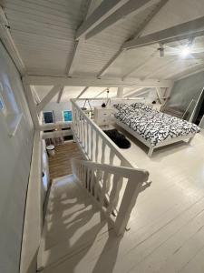 a bedroom with a bed and a staircase in a room at Lawenda in Turawa