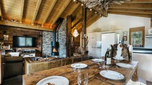 a kitchen with a wooden table with wine glasses at CHALET MOUTON a 4-Bedroom Alpine Chic Escape in Saas-Fee in Saas-Fee