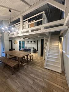 a dining room with a table and a loft bed at Lawenda in Turawa