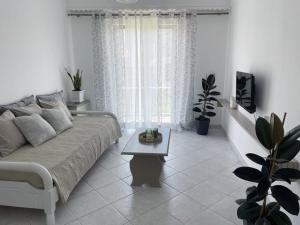 a living room with a couch and a coffee table at Philoxenia Apartments in Samos