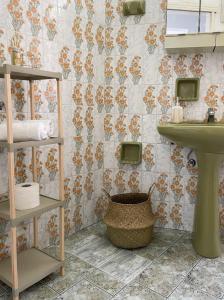 a bathroom with a sink and a toilet and a basket at Philoxenia Apartments in Samos