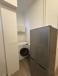 a kitchen with a refrigerator and a washing machine at Apartmány Hviezdoslavova in Piešťany