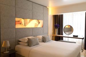 Vuode tai vuoteita majoituspaikassa Brasil Suites Boutique Hotel