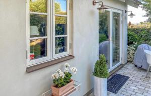 a porch with two windows and two potted plants at 1 Bedroom Gorgeous Apartment In Ystad in Ystad