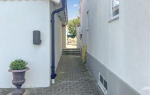 a narrow alley with a potted plant next to a building at 1 Bedroom Gorgeous Apartment In Ystad in Ystad +9 photos