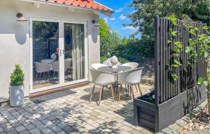 a patio with a table and chairs and a fence at 1 Bedroom Gorgeous Apartment In Ystad in Ystad