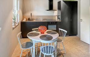 a small kitchen with a table and chairs in a room at 1 Bedroom Gorgeous Apartment In Ystad in Ystad