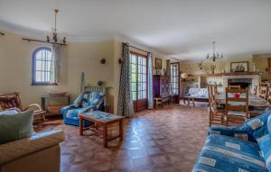a living room with blue couches and a table at 3 Bedroom Awesome Home In Seillans in Seillans