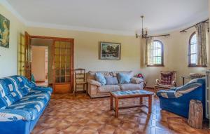 a living room with blue couches and a table at 3 Bedroom Awesome Home In Seillans in Seillans