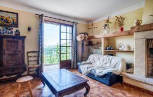 a living room with a couch and a fireplace at 3 Bedroom Awesome Home In Seillans in Seillans