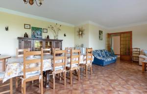 a dining room with a table and chairs and a couch at 3 Bedroom Awesome Home In Seillans in Seillans