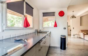 a kitchen with a counter top and two windows at Apartment In Villa With Pool in Callas