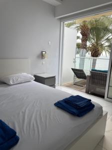 a bedroom with a bed with a view of the ocean at Nautica Luxe Beachfront in Voroklini