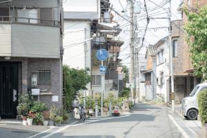 a street with a street sign on the side of a building at GuesthouseA in Osaka