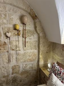 a bedroom with a stone wall with two hearts on the wall at Mini Home Valentina in Fasano