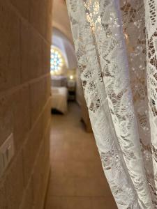 a hallway with a white curtain on a wall at Mini Home Valentina in Fasano +2 photos