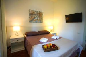 A bed or beds in a room at Villa Topazio
