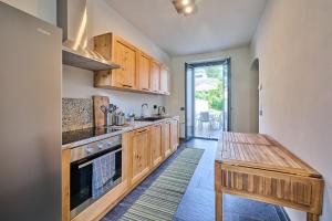 a kitchen with wooden cabinets and a wooden table at Villa Adriana in Lierna