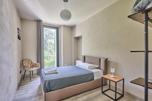 a small bedroom with a bed and a window at Villa Adriana in Lierna +49 photos
