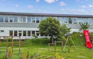 a building with a playground in front of it at 3 Bedroom Gorgeous Home In Kolbeinsvik in Kolbeinsvik