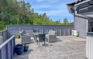a patio with chairs and a table on a deck at 3 Bedroom Gorgeous Home In Kolbeinsvik in Kolbeinsvik