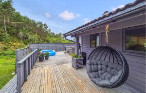 a porch with a swing on a deck at 3 Bedroom Gorgeous Home In Kolbeinsvik in Kolbeinsvik +9 photos