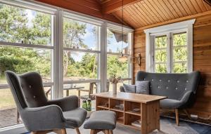 a room with two chairs and a table and windows at Nice Home In Tarm With Swimming Pool in Tarm +17 photos