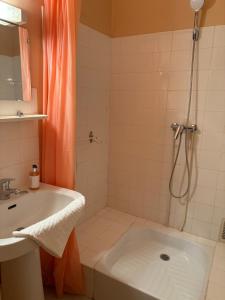 a bathroom with a shower and a tub and a sink at Studio Centre Vars Le Seignon in Vars