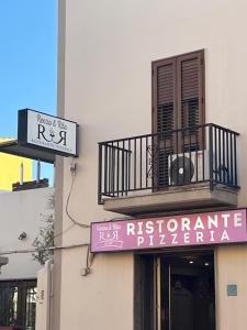 a sign on the side of a building with a balcony at Appartamenti Renzo&Rita3 Teresina in SantʼAntìoco