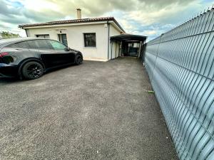 a car parked in front of a house at Chambre agréable, SDB privée, Clim, Vue Piscine, in Muret +1 photo