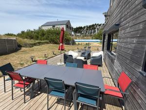 a patio with a table and chairs on a deck at Beach House in Port-Bail-sur-Mer +24 photos