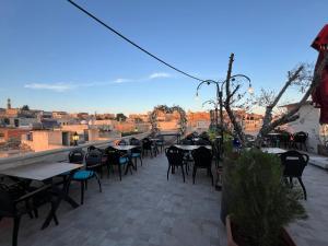 a patio with tables and chairs and a view of the city at Midyat Amaara Konağı Otel&Cafe in Midyat