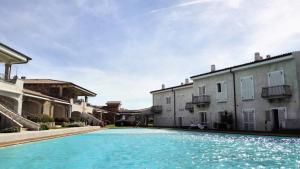 a swimming pool in front of some buildings at Sardinia Lighthouse Apartment in Palau