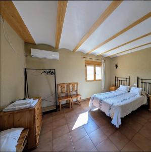 a bedroom with a bed and a mirror in it at Casa Rural La Granja in Letur