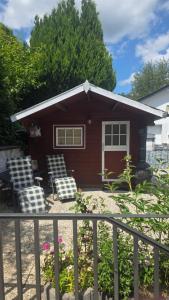 a small house with two chairs and a porch at Ruhe am See in Simmerath +48 photos