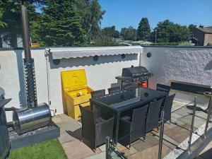 a patio with a grill and a fire place at Alocin cottage in Melmerby