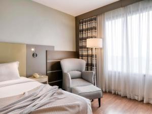 Cama ou camas em um quarto em Mercure Belo Horizonte Lourdes