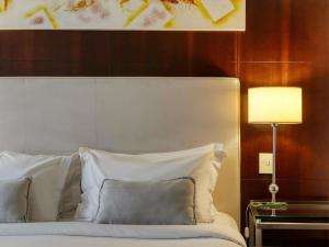 Cama ou camas em um quarto em Mercure Belo Horizonte Lourdes